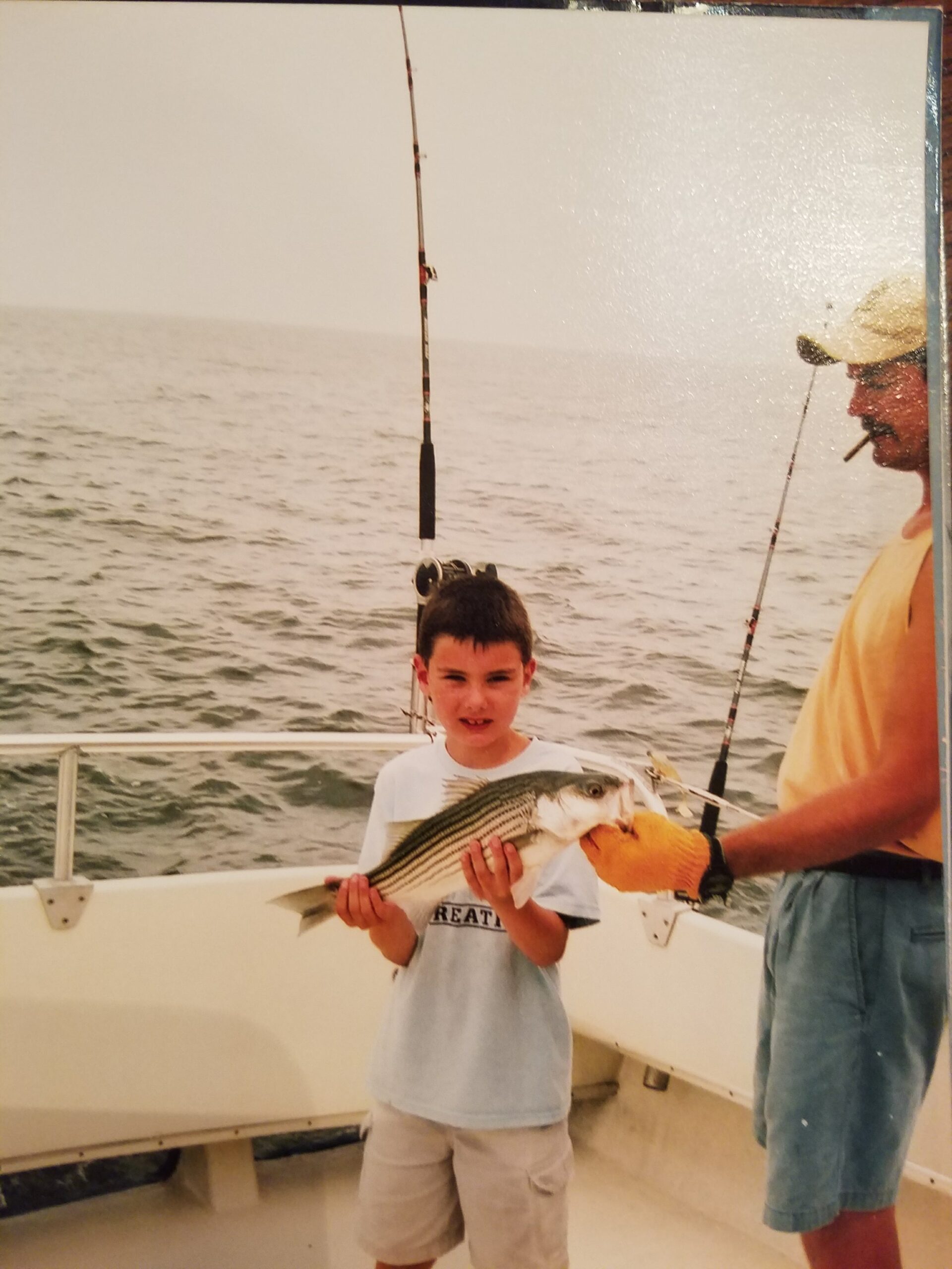 Trophy striped bass father and kid