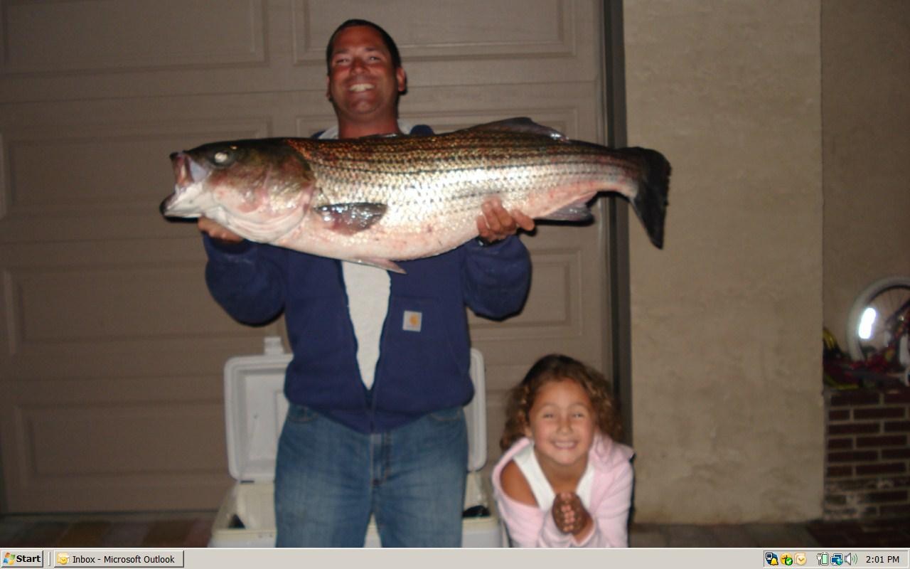 Angler with jack crevalle caught at night