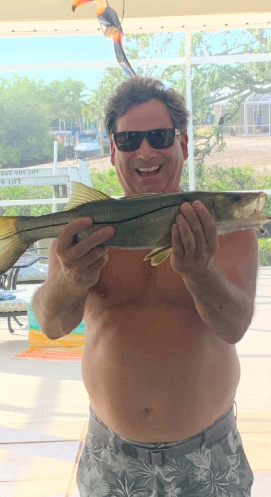 Angler holding mahi-mahi on offshore boat