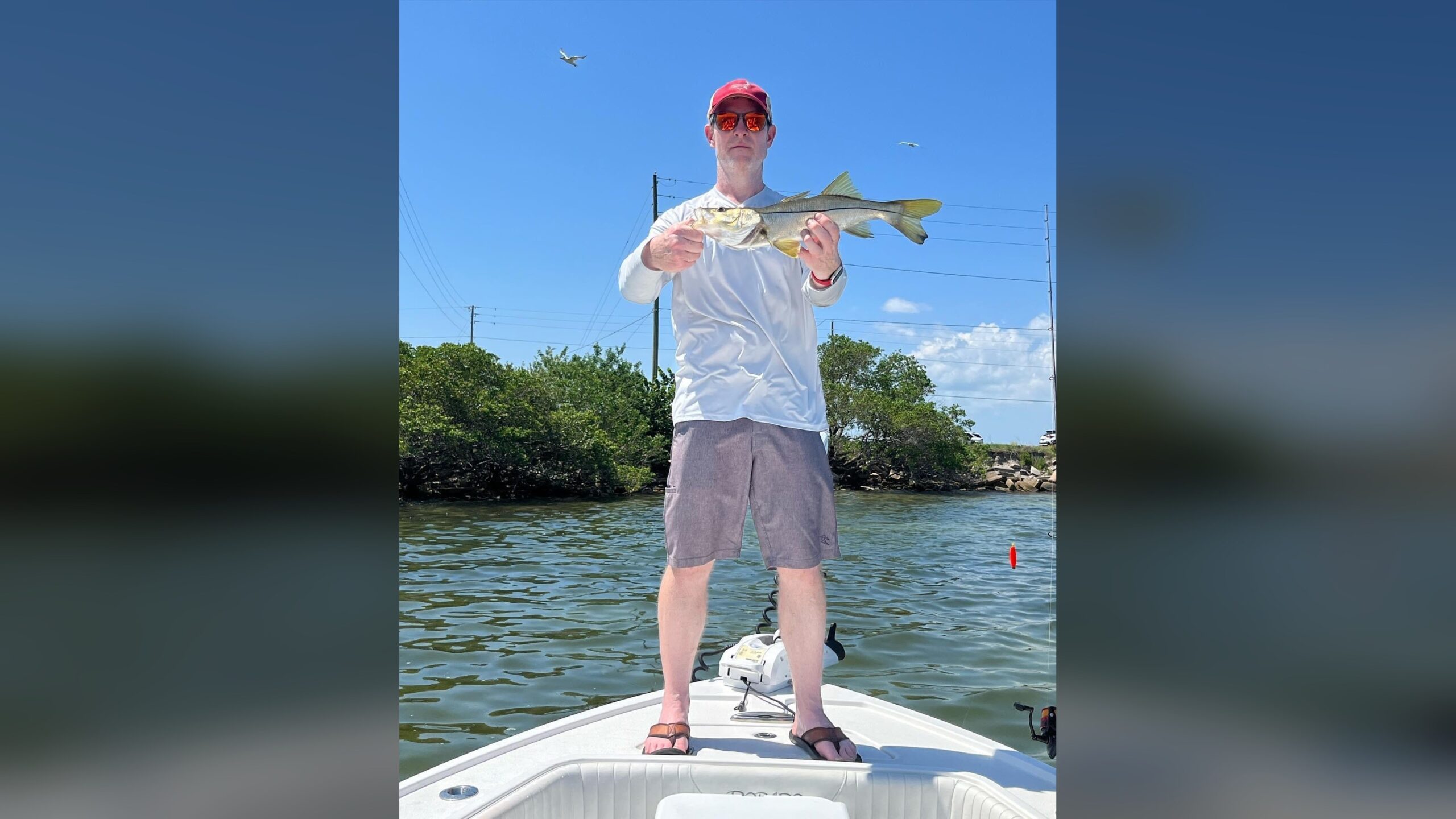 Angler holding snook caught in Florida inshore waters