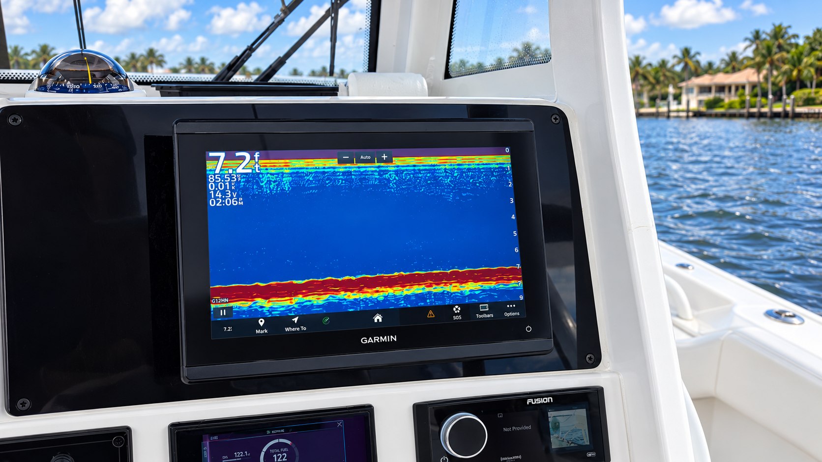 Garmin fish finder displaying sonar on a center-console fishing boat